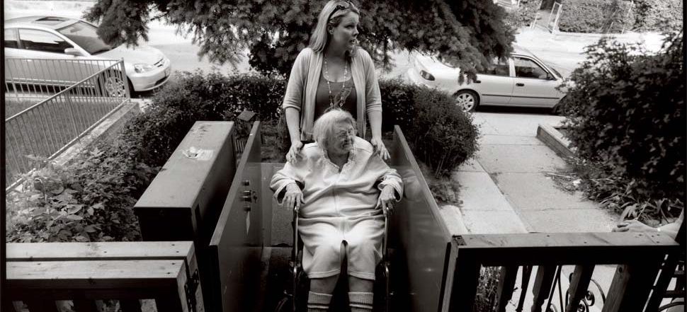 patient with caregiver on porch elevator